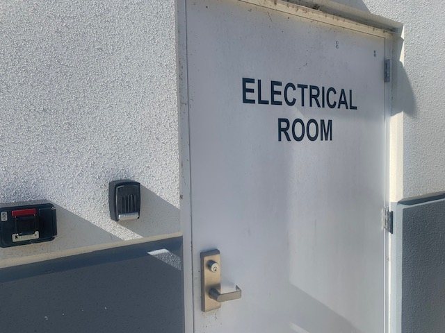 Electrical room door with a lever lock and a separate key lock box